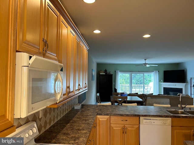 kitchen with white appliances, sink, and ceiling fan