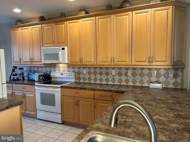 kitchen with white appliances, a toaster, light tile patterned floors, dark countertops, and backsplash