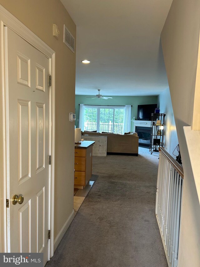 carpeted dining room featuring a chandelier, visible vents, and baseboards