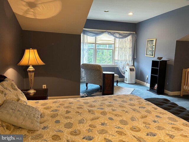 carpeted bedroom featuring lofted ceiling and baseboards