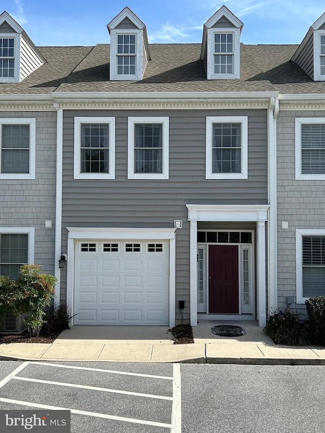 townhome / multi-family property featuring a garage