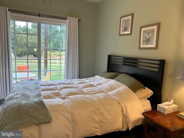 carpeted bedroom featuring a ceiling fan, access to outside, and visible vents