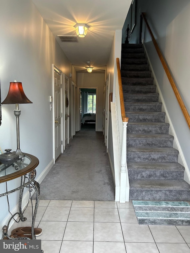 stairs featuring carpet flooring