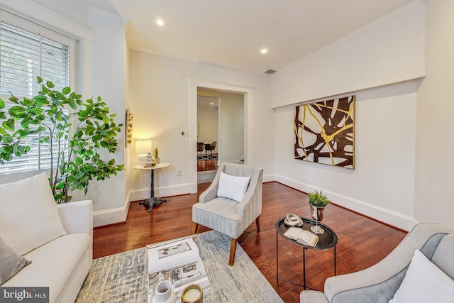 living area featuring crown molding and dark hardwood / wood-style floors