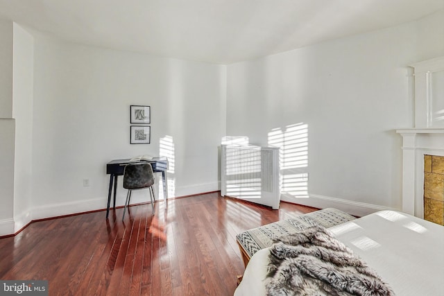 bedroom with multiple windows and wood-type flooring