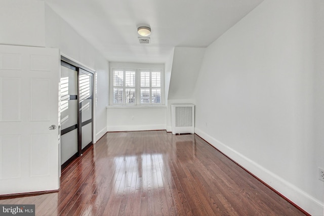 empty room with dark wood-type flooring