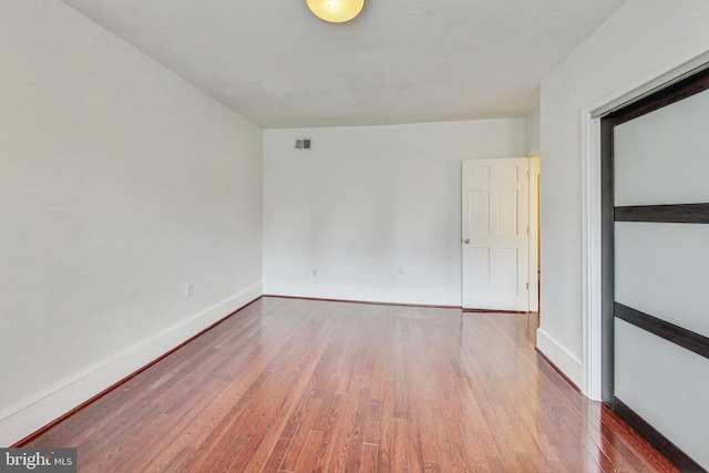 unfurnished room with hardwood / wood-style floors