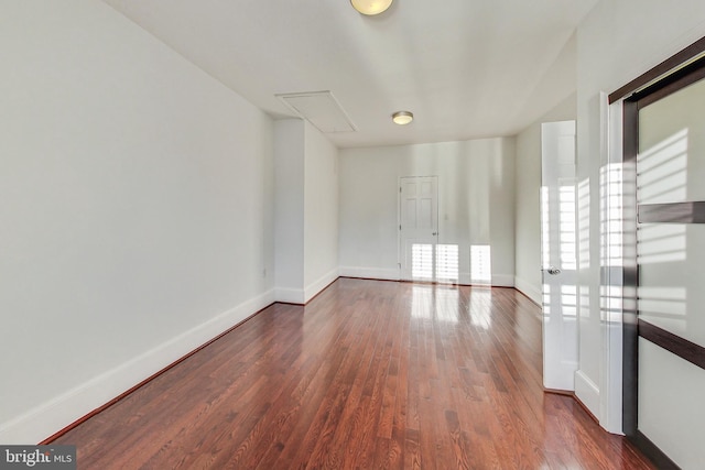 unfurnished room featuring dark wood-type flooring