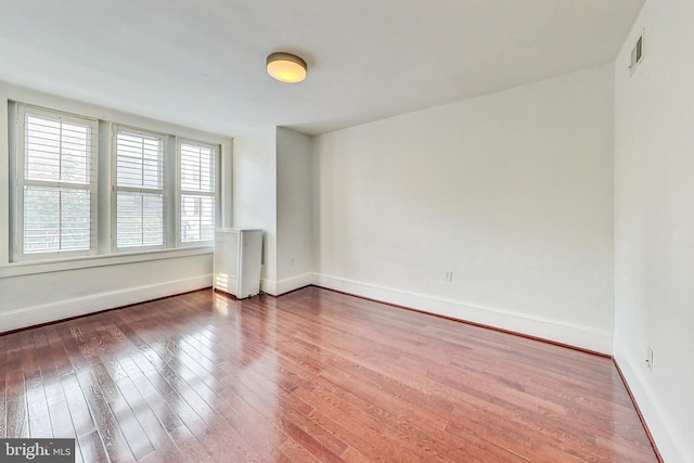 empty room with hardwood / wood-style floors