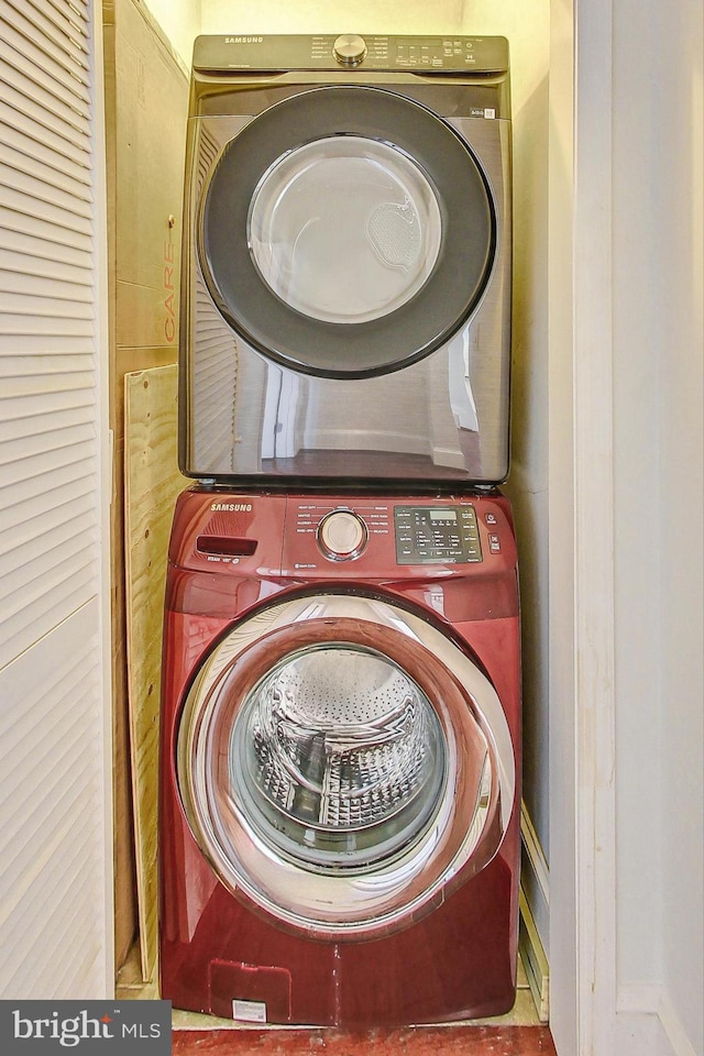 washroom featuring stacked washer and clothes dryer