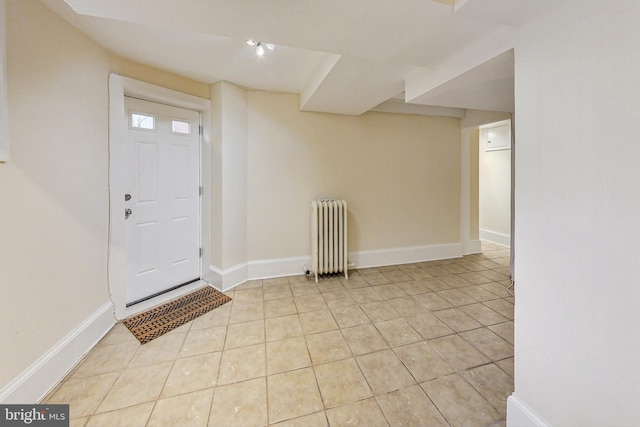 foyer with radiator heating unit and light tile patterned floors