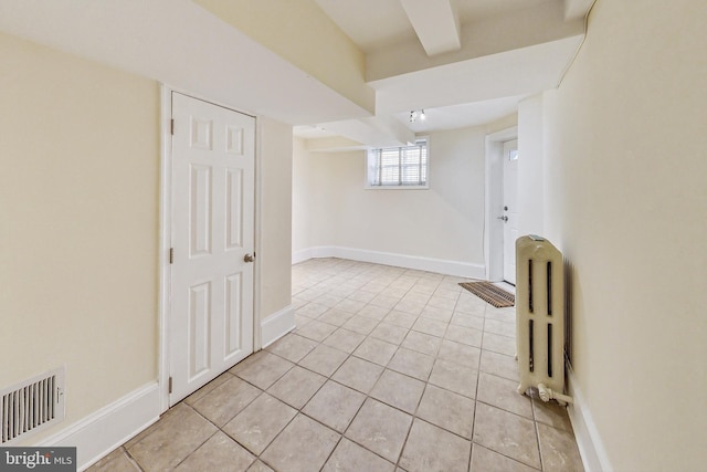 interior space featuring radiator and light tile patterned flooring