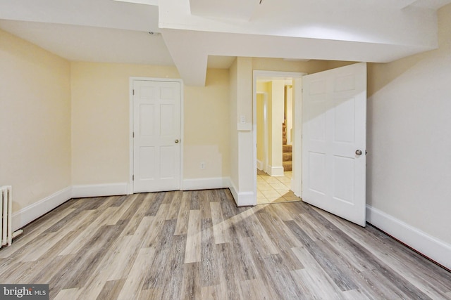 interior space featuring light hardwood / wood-style flooring and radiator heating unit