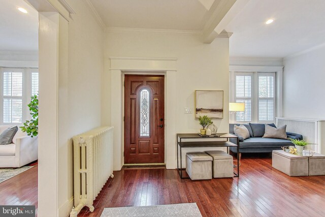 dining space with wood-type flooring and crown molding