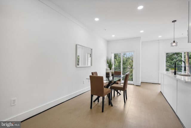 dining room featuring sink and a wealth of natural light