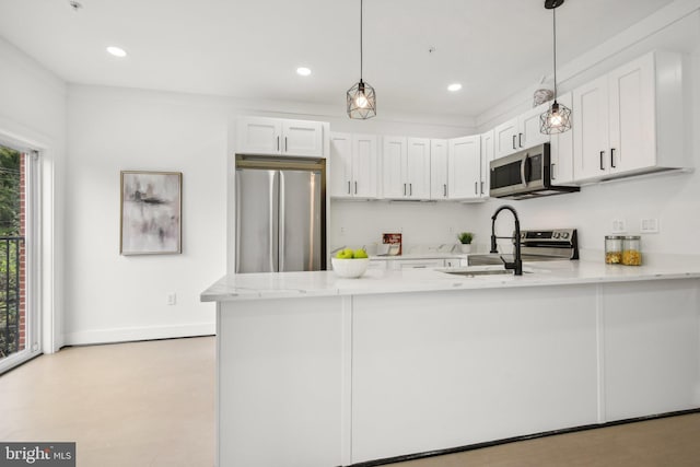 kitchen featuring white cabinets, pendant lighting, sink, kitchen peninsula, and appliances with stainless steel finishes