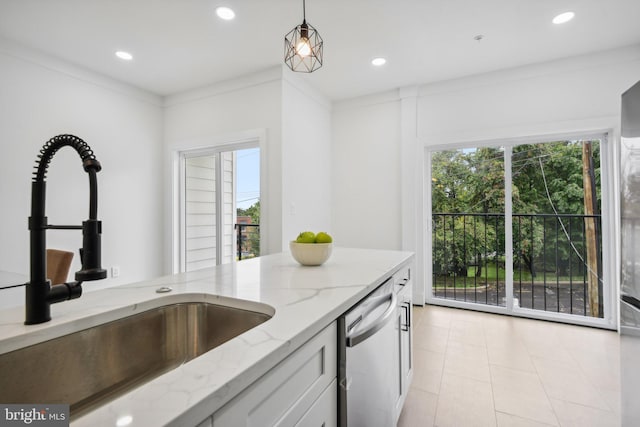 kitchen featuring pendant lighting, light stone counters, sink, ornamental molding, and stainless steel dishwasher