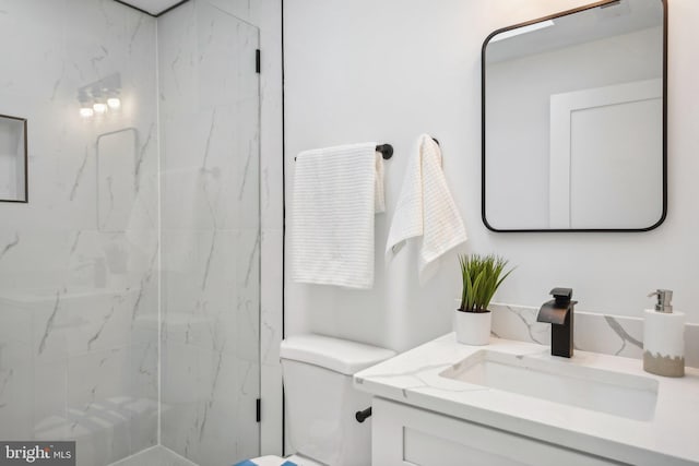 bathroom featuring vanity, toilet, and an enclosed shower