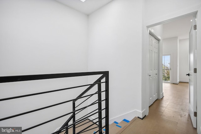 stairs with hardwood / wood-style floors