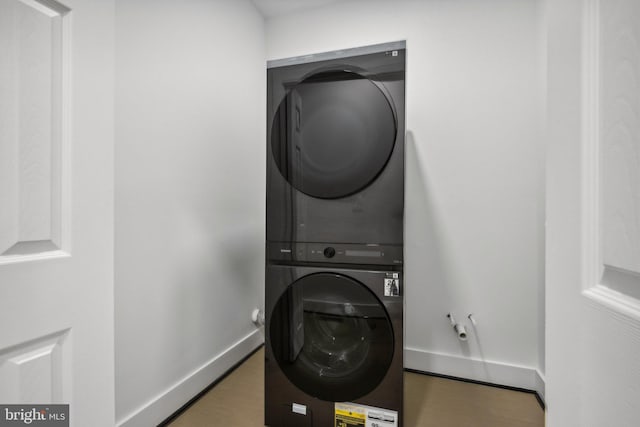 laundry area featuring stacked washing maching and dryer