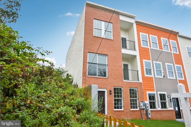 view of property featuring brick siding