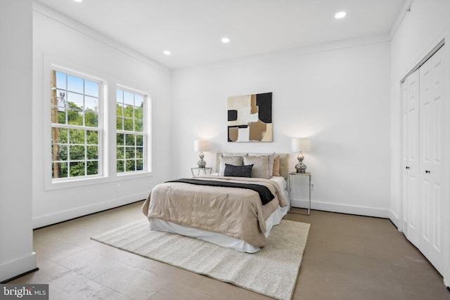 bedroom with crown molding and a closet