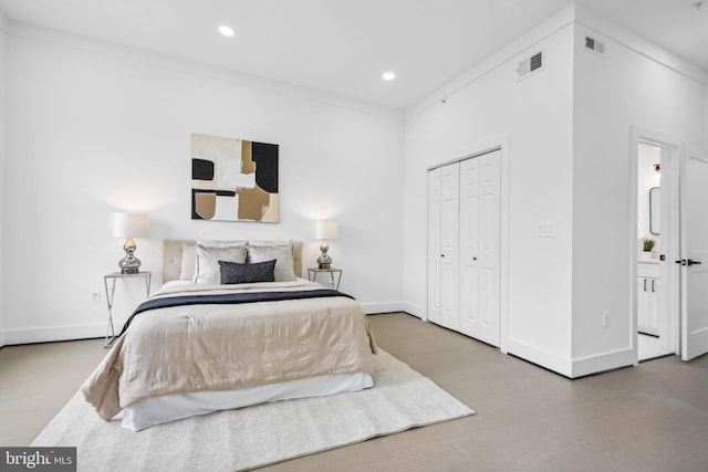 bedroom with ornamental molding, a closet, and hardwood / wood-style floors