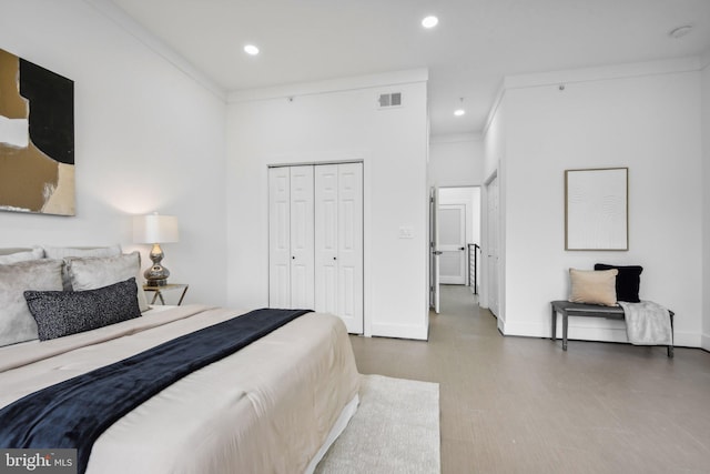 bedroom with ornamental molding and a closet