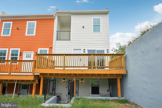 rear view of house featuring a wooden deck