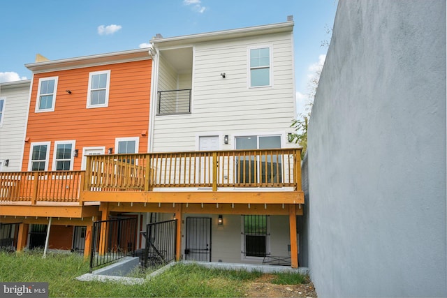 back of house featuring a wooden deck