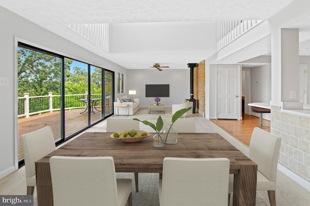 dining space with a textured ceiling and ceiling fan