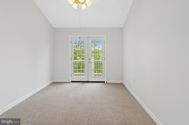 carpeted empty room featuring french doors