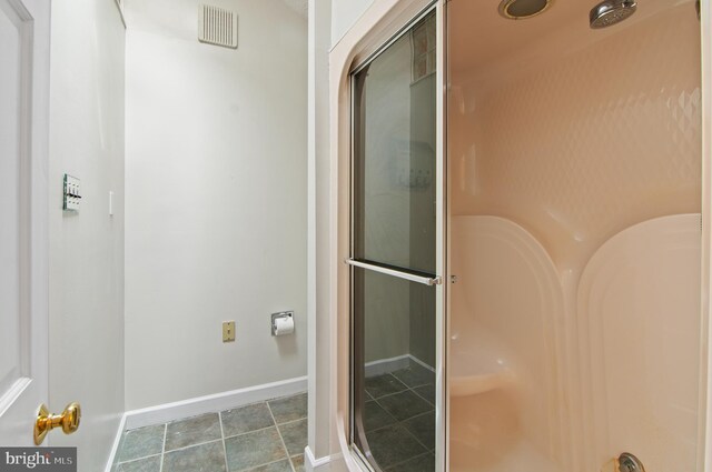 bathroom with walk in shower and tile patterned floors