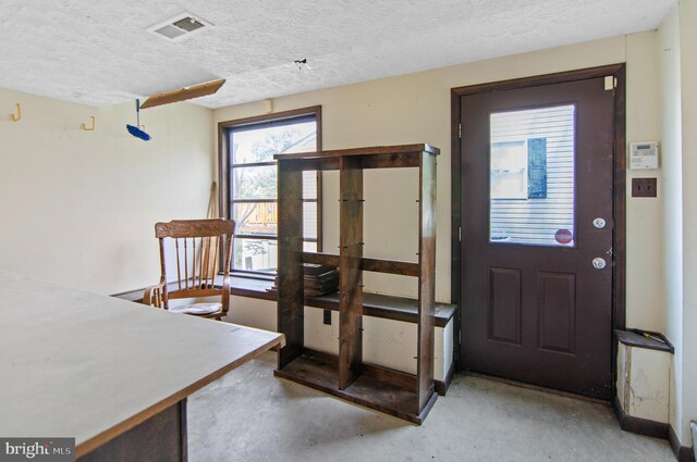 foyer featuring a textured ceiling