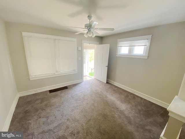 carpeted empty room featuring ceiling fan