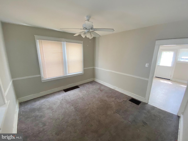 carpeted spare room featuring ceiling fan