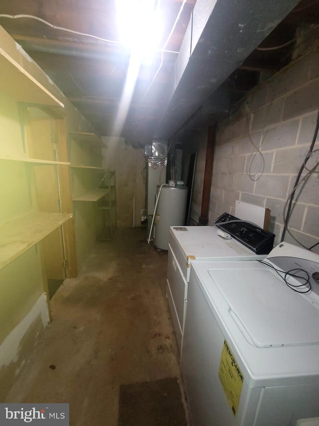 basement featuring washing machine and clothes dryer and gas water heater