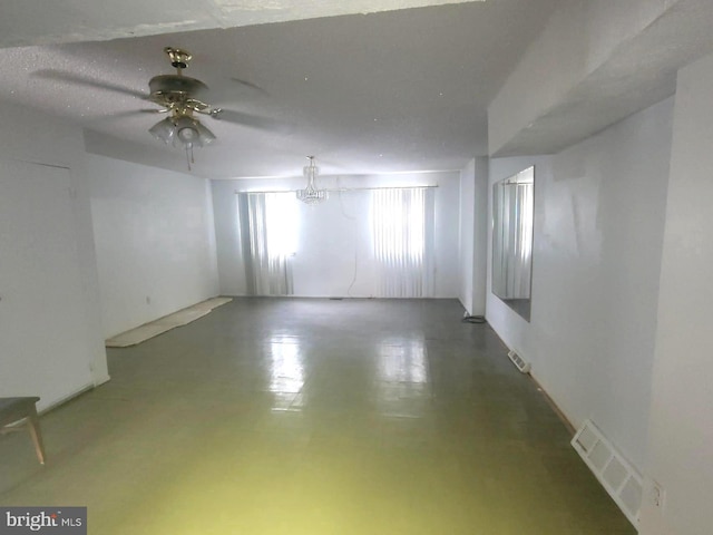 spare room featuring concrete flooring, a textured ceiling, and ceiling fan