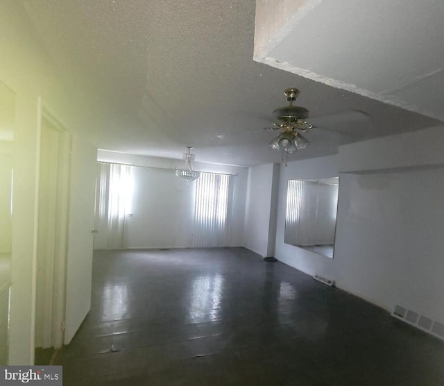 spare room featuring a textured ceiling and ceiling fan