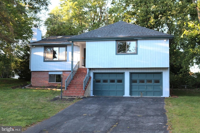 bi-level home with a front yard and a garage