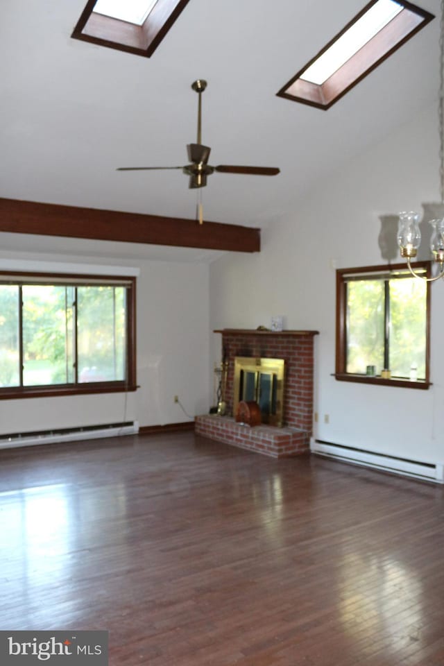 unfurnished living room featuring a fireplace, lofted ceiling with skylight, ceiling fan with notable chandelier, dark hardwood / wood-style floors, and a baseboard heating unit