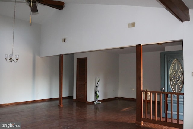 spare room with dark wood-type flooring, ceiling fan with notable chandelier, and high vaulted ceiling