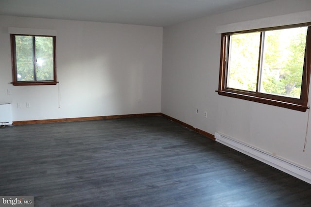 unfurnished room featuring baseboard heating, radiator heating unit, and dark hardwood / wood-style flooring