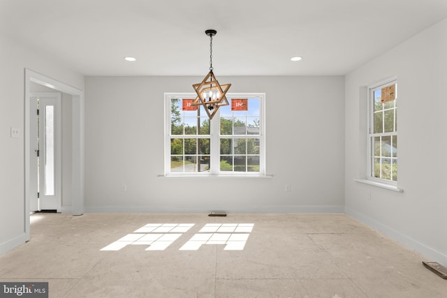 unfurnished dining area with a notable chandelier and a healthy amount of sunlight