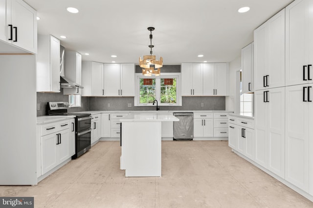 kitchen featuring appliances with stainless steel finishes, a kitchen island, hanging light fixtures, white cabinetry, and a chandelier