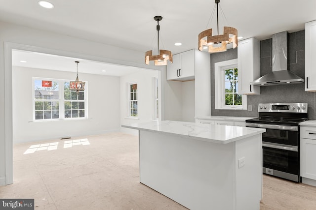 kitchen with electric stove, wall chimney exhaust hood, plenty of natural light, and white cabinets