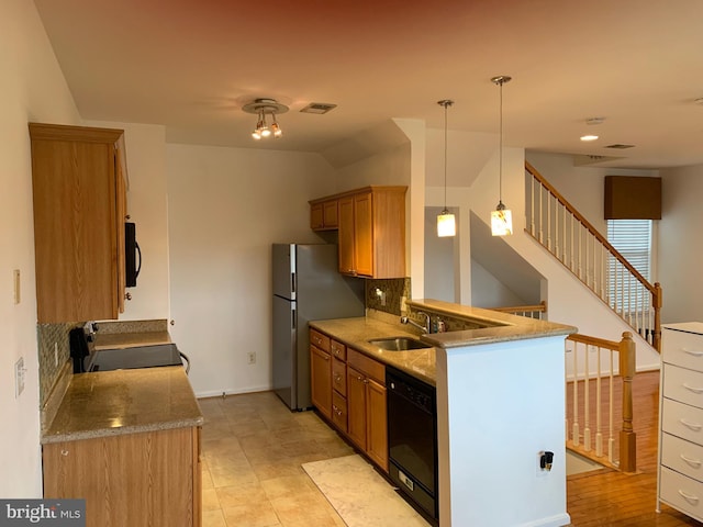 kitchen with hanging light fixtures, sink, decorative backsplash, and black appliances