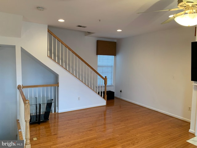 unfurnished living room featuring ceiling fan and light hardwood / wood-style floors