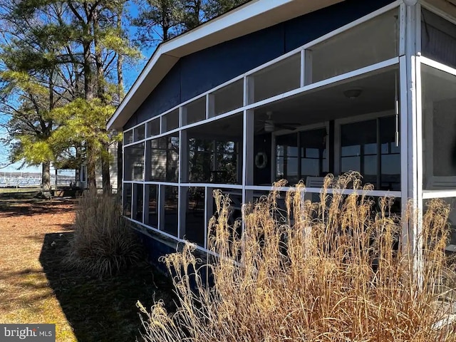 view of side of property featuring a sunroom