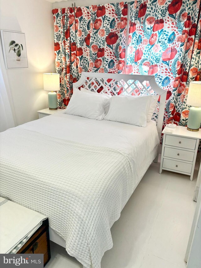 bedroom featuring wooden walls